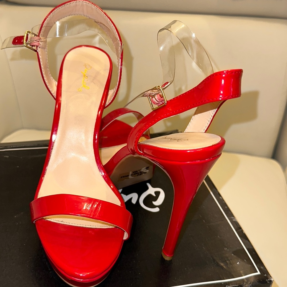 Shiny red open toe heels